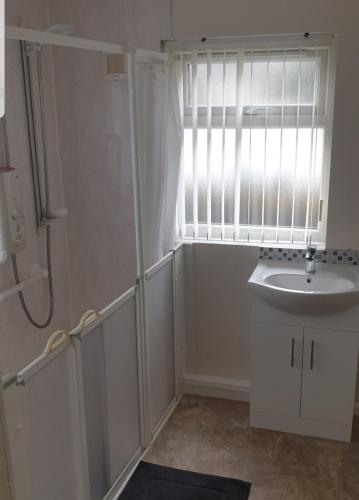 a bathroom with a sink and a window at Snowdonia miners cottage in Blaenau-Ffestiniog