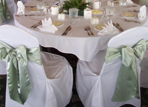 a table with a white tablecloth and chairs with a white tablestration at Abbey Hotel in Ballyvourney