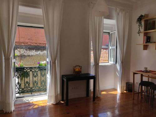 une chambre avec une table devant une fenêtre dans l'établissement Paço da Rainha Apartment, à Lisbonne