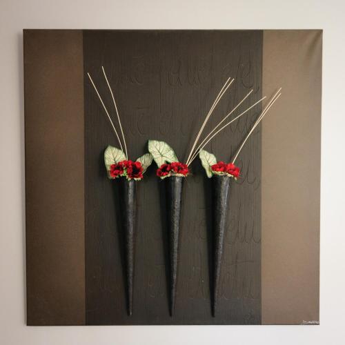 three black vases with red flowers on a wall at The Originals City, Hôtel Dau Ly, Lyon Est in Bron