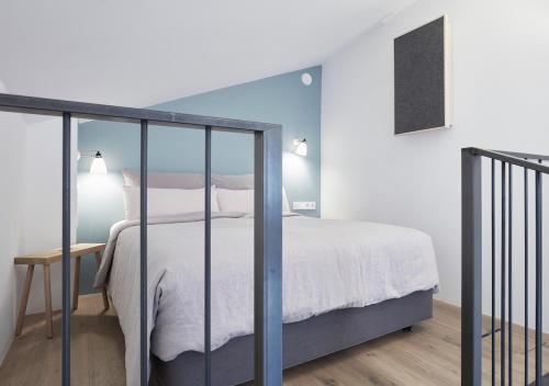 a bedroom with a white bed and a table at Faktorei in Innsbruck