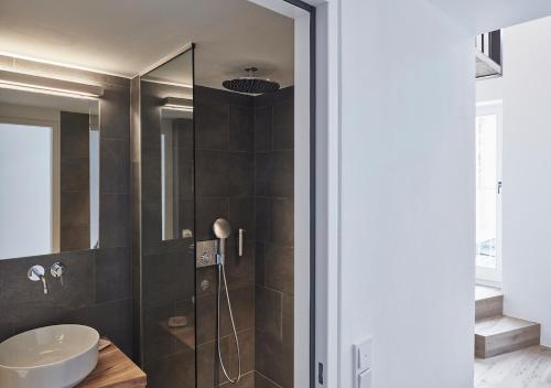 a bathroom with a sink and a shower at Faktorei in Innsbruck
