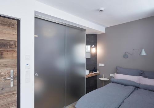 a bedroom with a bed and a sliding glass door at Faktorei in Innsbruck