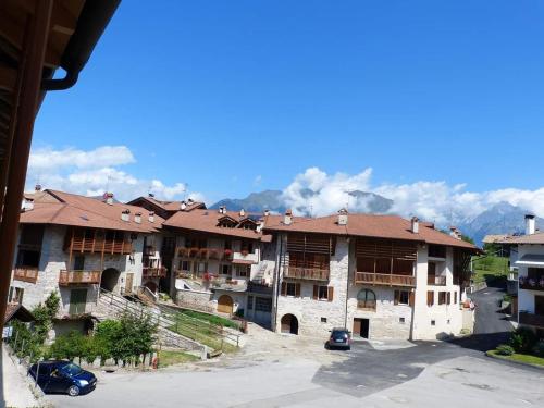 a group of buildings with mountains in the background at Nido di Rondine B&B in Comano Terme