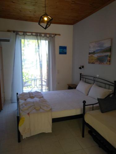 a bedroom with a bed and a window at mare di zante "mare di levante" in Alikanas