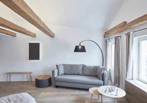 a living room with a blue couch and a table at Faktorei in Innsbruck