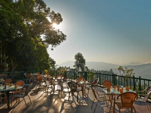 a row of tables and chairs on a patio at Club Mahindra Lake View Munnar in Chinnakanal