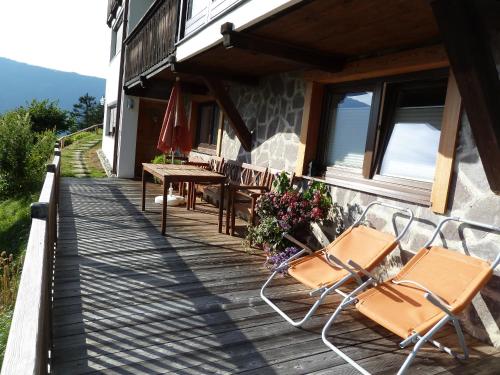 a porch of a house with chairs and a table at Haus Auer in Jerzens