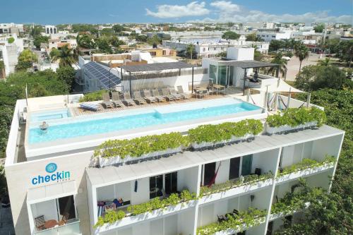 an aerial view of a building with a swimming pool at Papaya 15 Apartments in Playa del Carmen