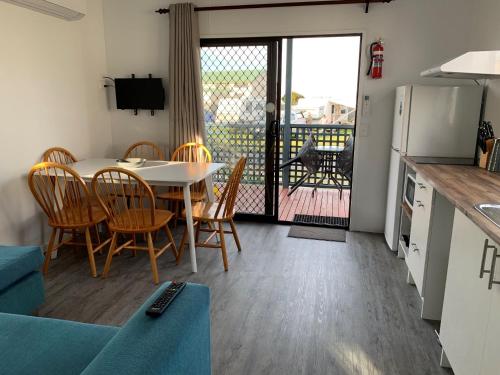 a kitchen and dining room with a table and chairs at Swansea Holiday Park Tasmania in Swansea