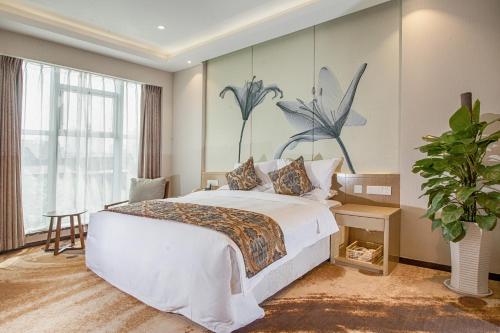 - une chambre avec un grand lit orné d'une peinture murale dans l'établissement Xi'an Peace Arch Hotel, à Xi'an
