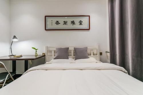 Voodi või voodid majutusasutuse Ancient City Wall Home Apartment Xi'an toas