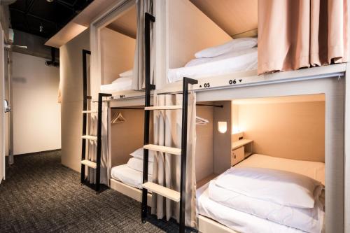 two bunk beds in a hostel room at UNPLAN Shinjuku in Tokyo