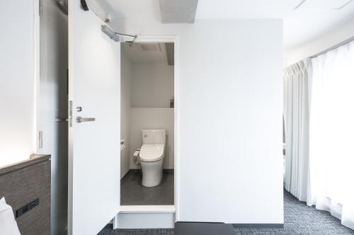 a bathroom with a toilet in a room at UNPLAN Shinjuku in Tokyo