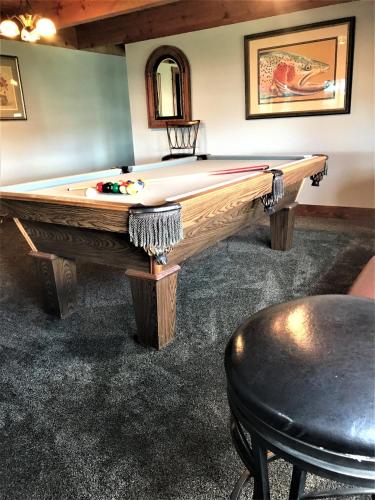 a pool table in the middle of a room at Drift Lodge in Island Park