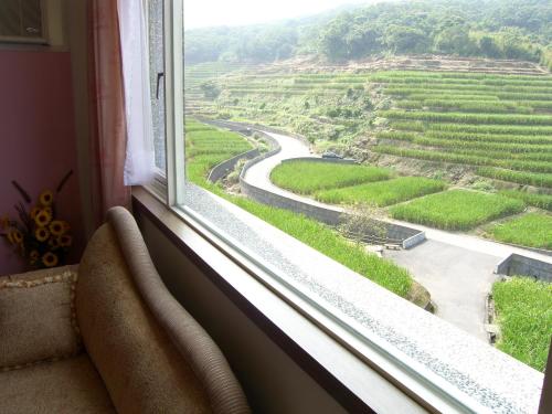 a window with a view of a winding road at Emoonten Homestay in Sanzhi