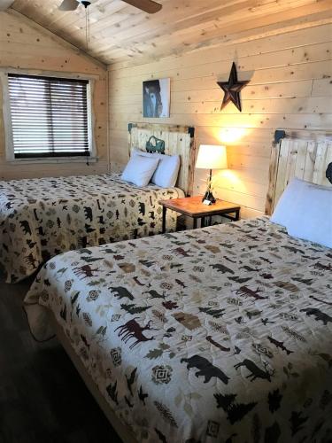 a bedroom with two beds and a star on the wall at Drift Lodge in Island Park