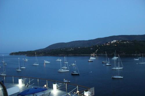 a group of boats sitting in a body of water at Hotel Plaza in Porto Azzurro