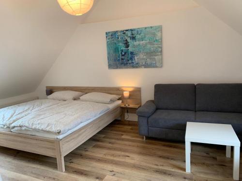 a bedroom with a bed and a couch at Ferienhaus Moritz in Pommern