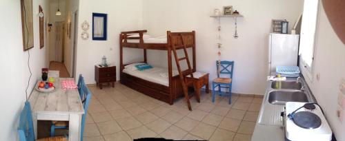 a small kitchen with a bunk bed in a room at Villa Costa Studios in Vathi, Sifnos