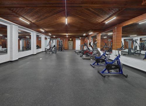 a gym with a row of treadms and cardio machines at Crestwood Hotel in Hinton