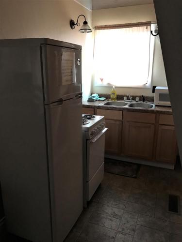 a kitchen with a stainless steel refrigerator and a stove at Drift Lodge in Island Park
