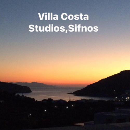 a sunset over the water with the words villa costa studios and ships at Villa Costa Studios in Vathi, Sifnos