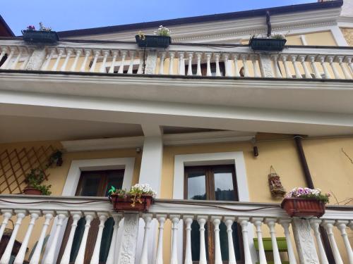 a building with balconies and potted plants on it at Le Terrazze Sul Pollino B&B in Civita