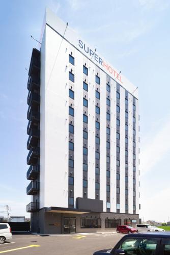 a building with a sign on the side of it at Super Hotel Anan Tomioka in Anan