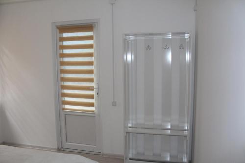 a glass shower in a room with a window at Park Hostel Osh in Osh