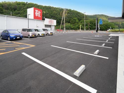 a parking lot with cars parked in it at Super Hotel Anan Tomioka in Anan