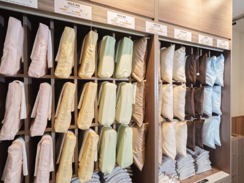 a closet filled with lots of different types of shoes at Super Hotel Anan Tomioka in Anan