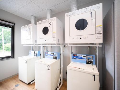 a laboratory with four microwaves and machines on display at Super Hotel Anan Tomioka in Anan