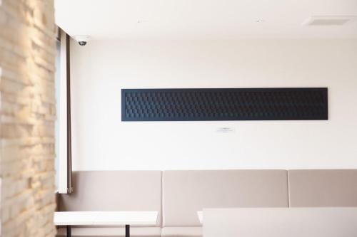 a kitchen with a white stove top oven next to a wall at Super Hotel Anan Tomioka in Anan