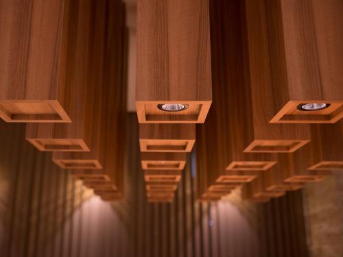 a row of curtains in a room with lights at Super Hotel Anan Tomioka in Anan