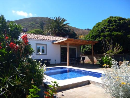 a villa with a swimming pool in a garden at Casa Domi in La Esperanza