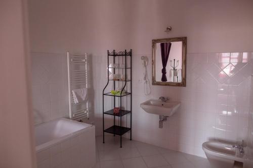 a bathroom with a sink and a toilet and a mirror at Zámek Napajedla in Napajedla