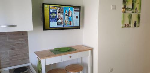 a tv hanging on a wall in a room at ele&gio accomodation in Tropea