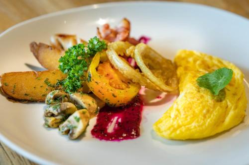 a white plate of food with shrimp and other foods at Ananda Ubud Resort in Ubud