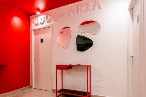 a red and white wall with a sign on it at Manzoni Elements in Milazzo