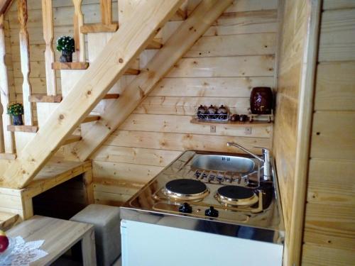 a kitchen with a stove top in a wooden cabin at Timber House in Tivat