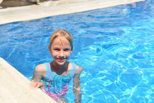 a young girl in a swimming pool at Kandelor Hotel in Alanya
