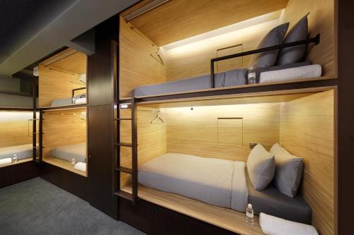 a room with two bunk beds in it at The Pod at Beach Road Boutique Capsule Hotel in Singapore