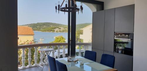 a dining room with a view of the water at Apartments Perina in Tisno