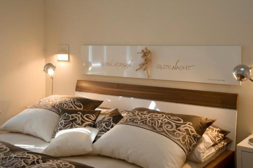 a bedroom with a bed with pillows on it at Apartments in Warnemuende in Warnemünde