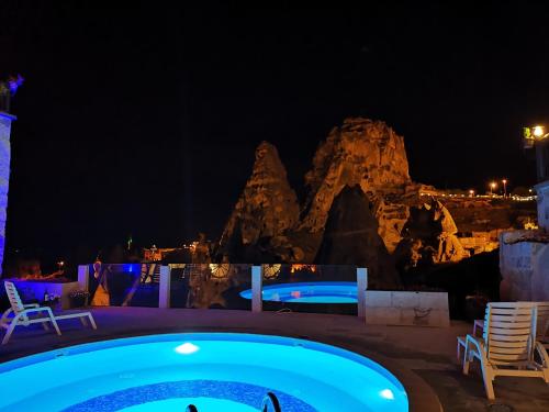 a night view of the pool at the resort at Hermes Cave Hotel in Uçhisar