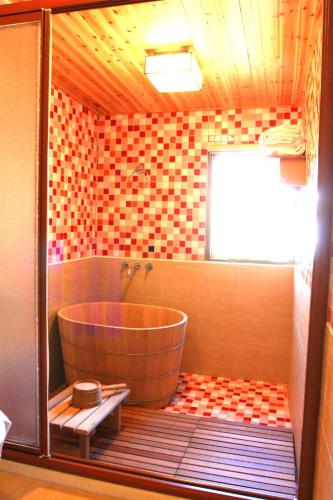 a bathroom with a large tub in a room at Hualien Tourism Sugar Factory Hotel in Guangfu