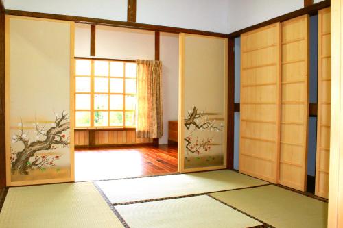 an empty room with a door and a window at Hualien Tourism Sugar Factory Hotel in Guangfu