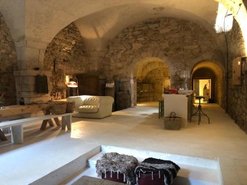 ein Wohnzimmer mit Sofa und Tisch in der Unterkunft La Manufacture Royale 1739 in Montolieu