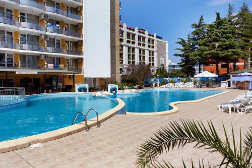 a large swimming pool in front of a building at Hotel Yantra in Sunny Beach